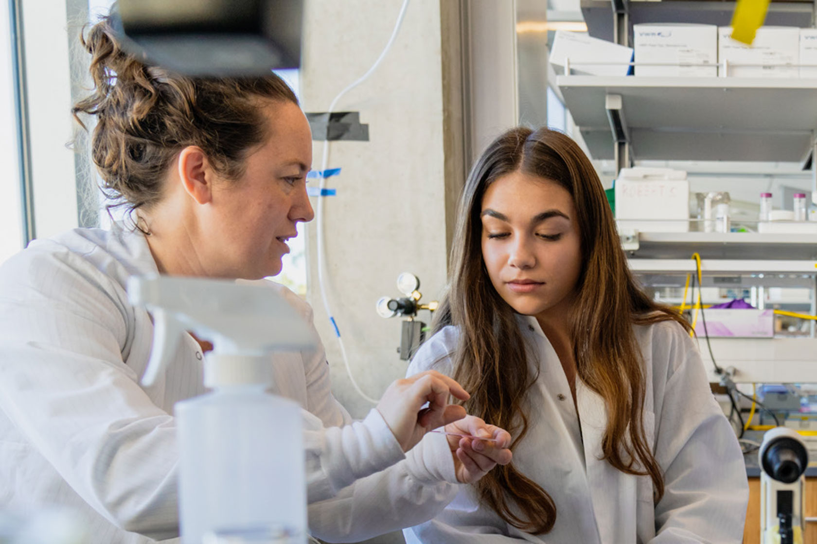 A professor and student working in a lab.